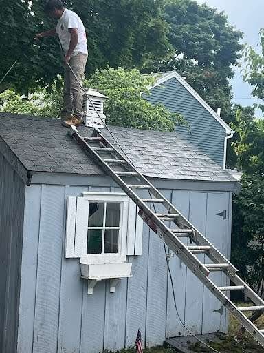 roof of shed being pressure washed